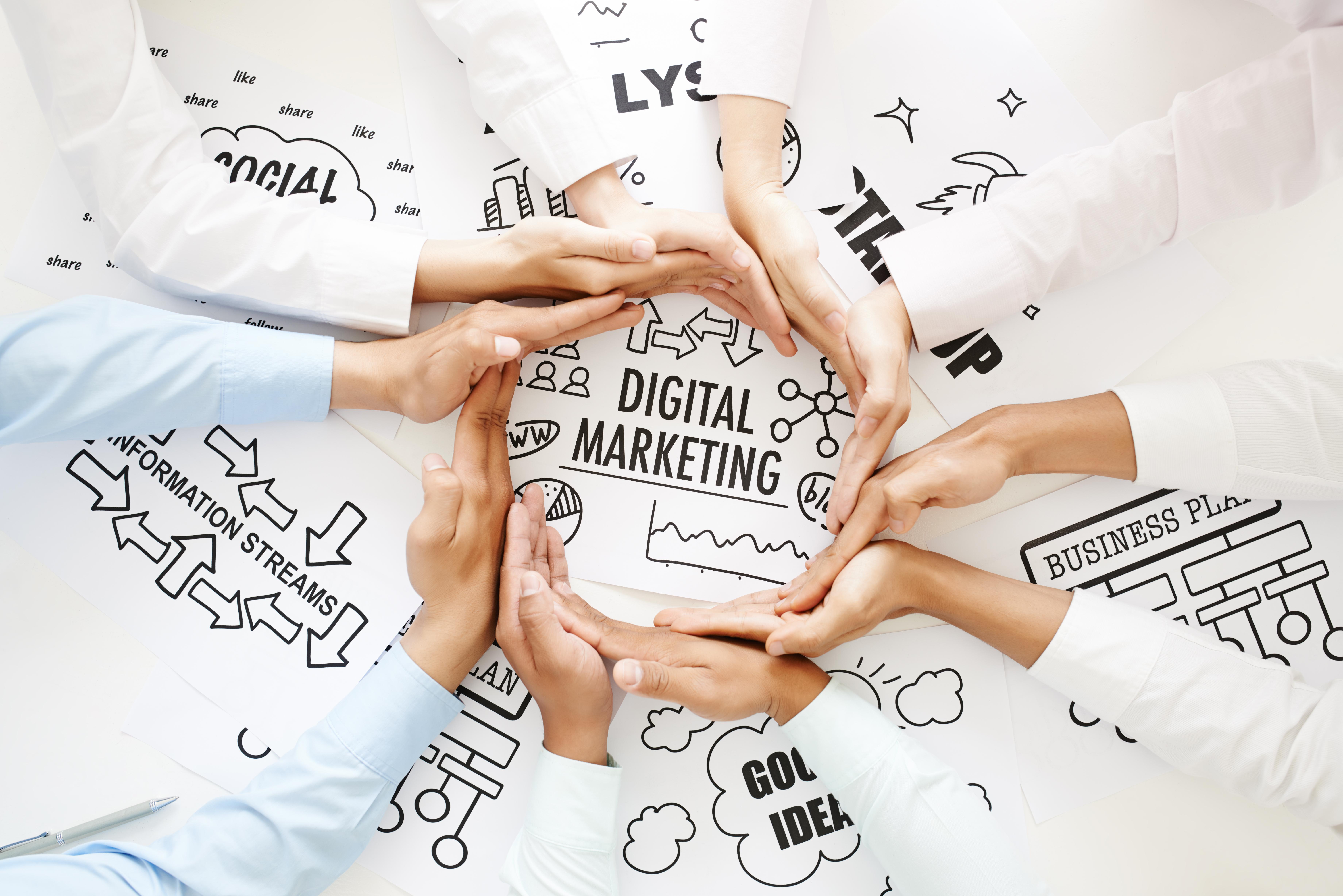 Business people making circle out of hands to emphasize digital marketing concept